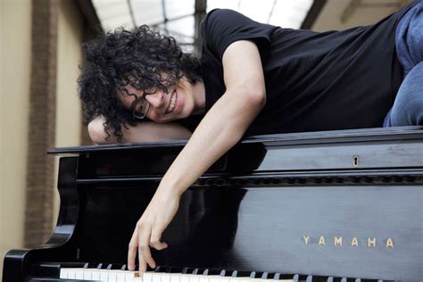 Fotografia di Giovanni Allevi al pianoforte, con un'espressione riflessiva.